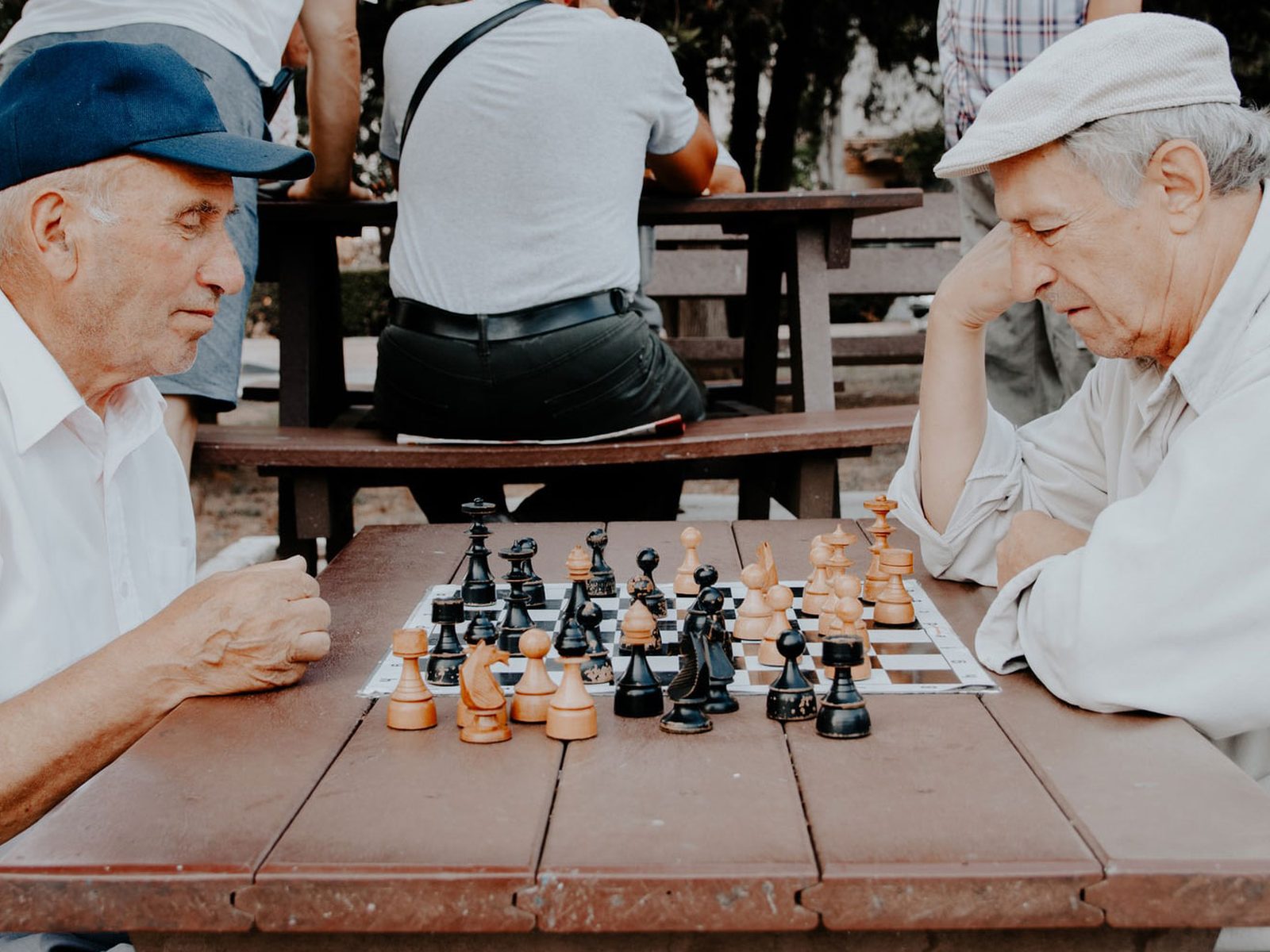 Two people playing a board game together at a table